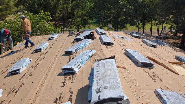 Crew members getting the  IKO Dynasty Shingles in place.
