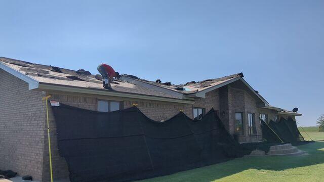 Attaching the catch all and removing the shingles.