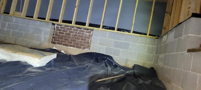 Fallen Insulation and Exposed Brick & Wood Panels