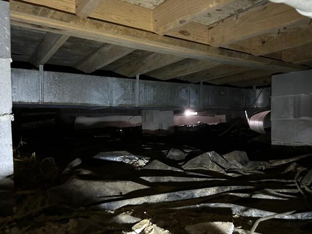 The crawlspace was previously encapsulated with inadequate material.