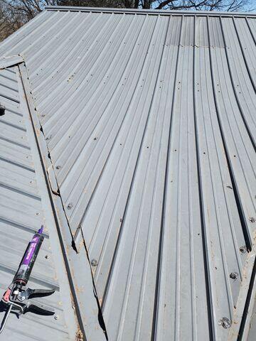 Replacing the metal roof back in place.