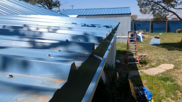Gutters being instaled to the front of Home.