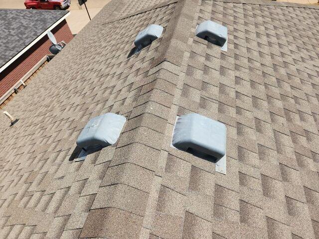 Hail damage to the vents and roof.