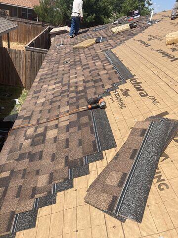 Shingles being placed on the roof.