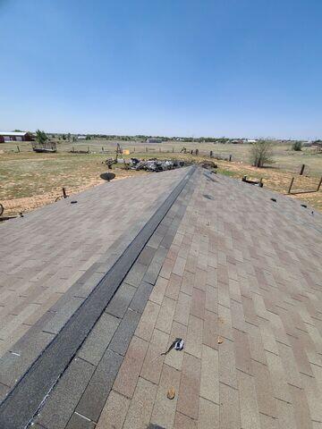 Replacing the shingles on the ridge.