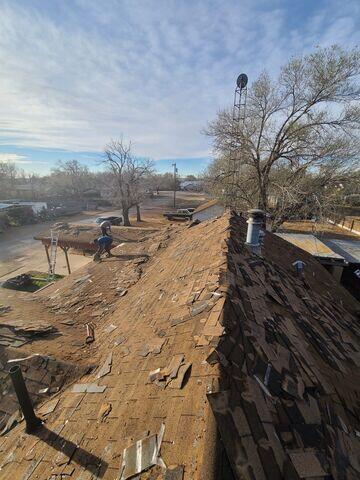 Fortenberry's Roofing Crew Removing old shingles