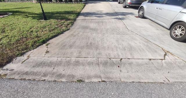 Cracked and Settling Concrete Driveway