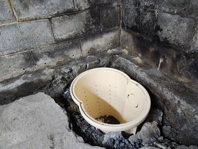 A close-up of a sump pump being installed.