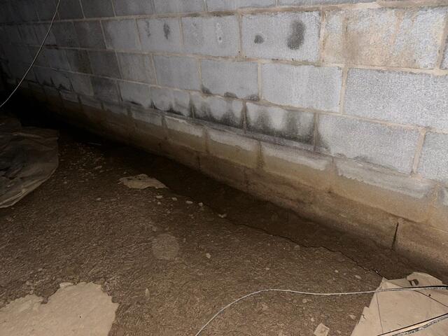 A close-up of the crawlspace before our crew started working on it.