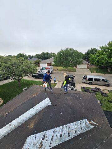Team member cleaning and blowing of debris from the roof.