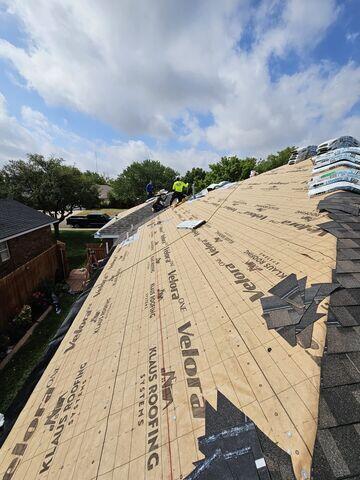 Crew members starting the process of setting the shingles.