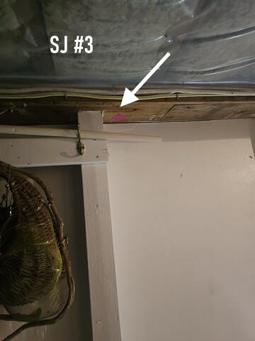 2 X 4 lumber holding up main beam under garage