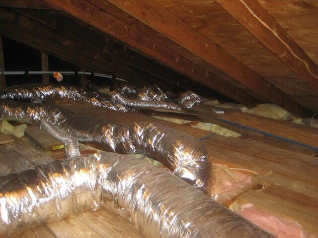 Before: Old Fiberglass Insulation and Air Ducts