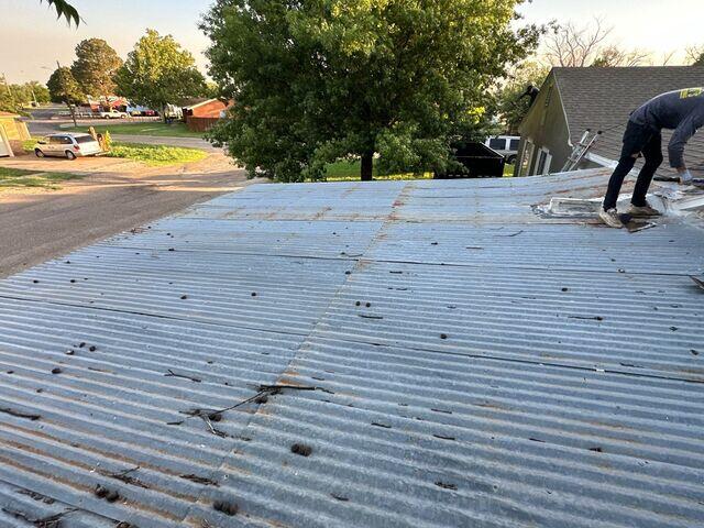 Removing the old tin Roof.
