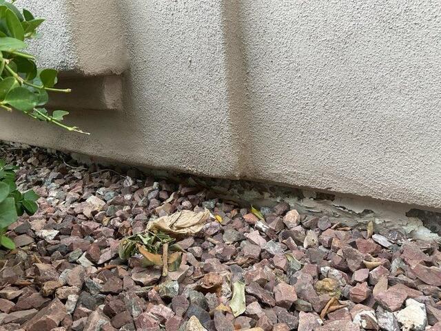Symptoms of Corrosion in a Concrete Stem Wall: Flaking paint in Chandler, AZ