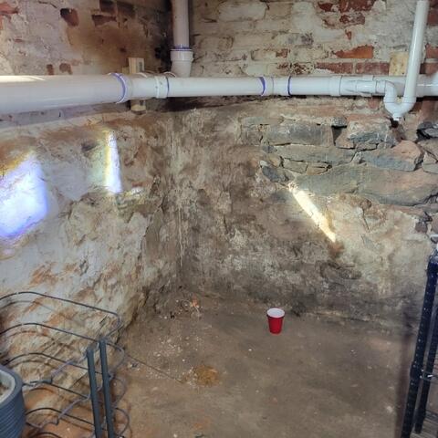 Staining and moisture spots along foundation wall