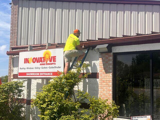 Jed Holding the Gutter Shutter trough during Installation