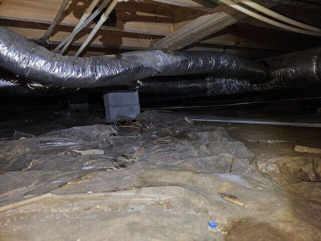 This is how the crawl space appeared before our crew started working on it.