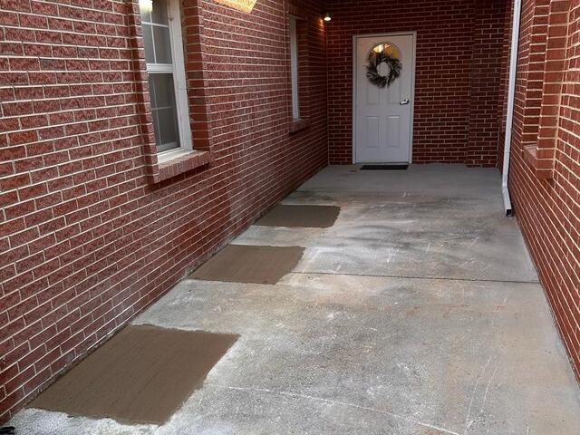 A view from the side of the church showing the backfilled holes.