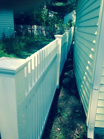 <p>PVC fence installed behind garage on property line.</p>
