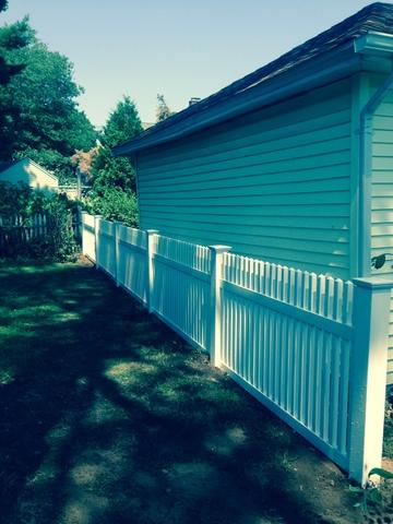 <p>PVC fence installed behind garage on property line</p>