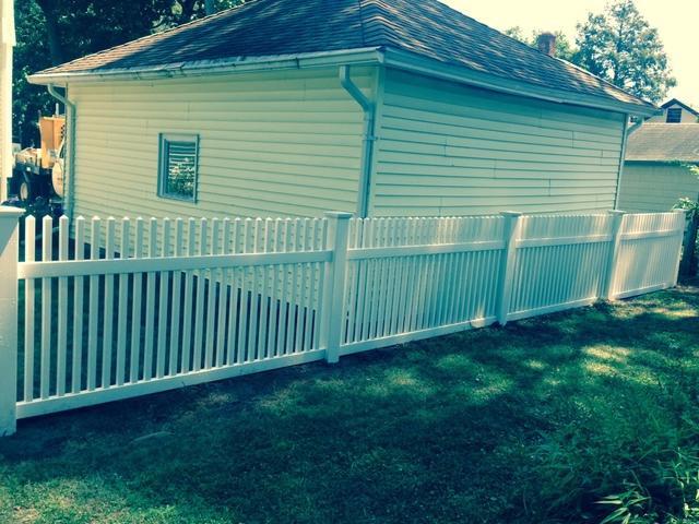 <p>PVC fence installed behind garage on property line.</p>