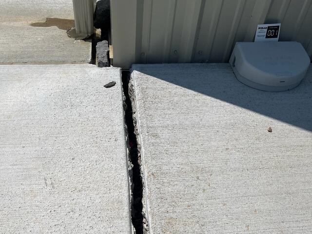 A close-up of the crack outside the commercial building.