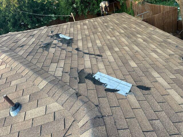 Patched work on shingles from a previous repair.