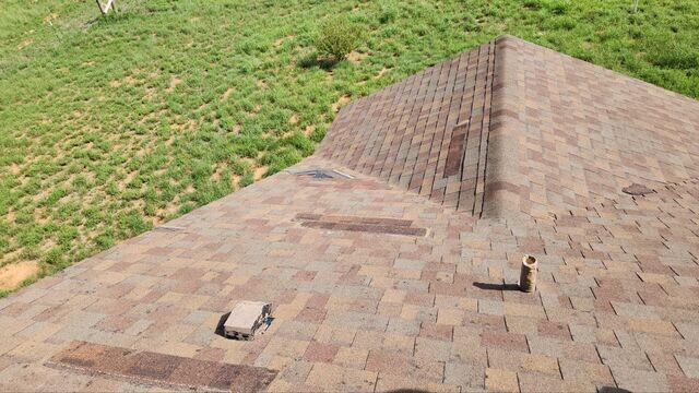Missing shingles and damage to the roof.