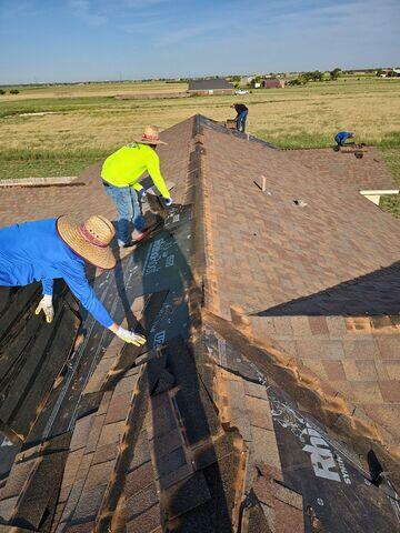 Team members removing the shingles.