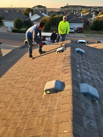 Crew members removing the shingles.