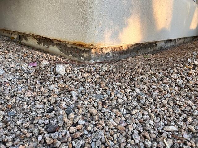 Symptoms of a corrosion problem in a concrete stem wall: peeling or flaking paint in Phoenix, Arizona