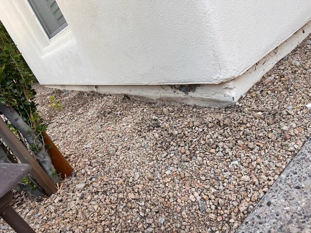 Symptoms of corrosion problems in a concrete stem wall: spalling concrete in Phoenix, Arizona
