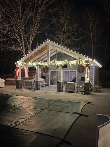 Inviting lights on poolhouse