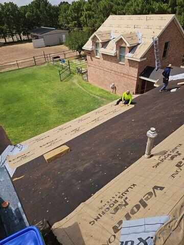 Roofing crew putting in the work.