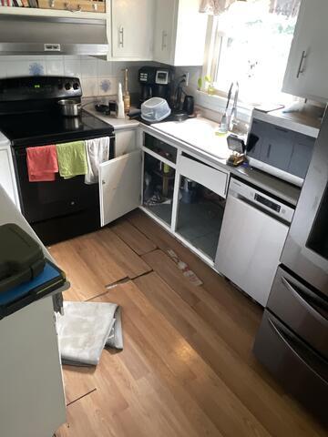 Buckling Floorboards from Kitchen Sink Leak in Seymour, CT.