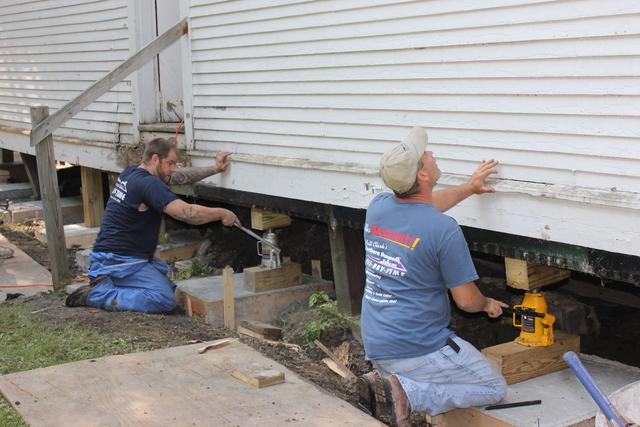 Our team lifting the barn to prepare for installing the new piers. 