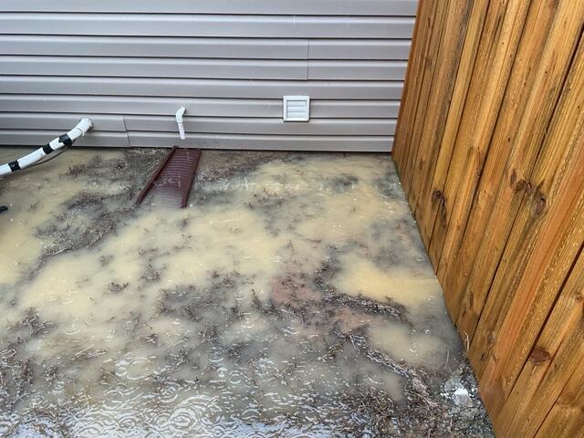Poor Yard Grading Causes Water to Pool Against Foundation