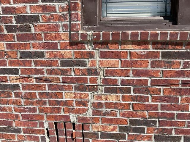 Wide Vertical Wall Crack Below Window