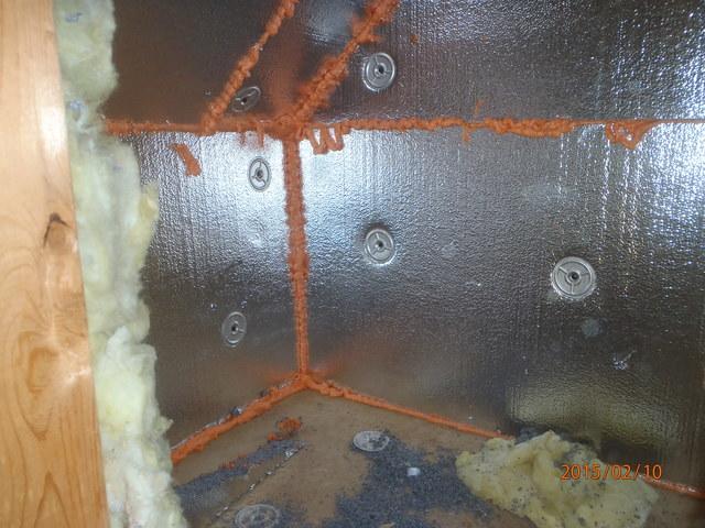 This photo captures SilverGlo being installed along the walls and air sealing the cracks to prevent air leakage. 