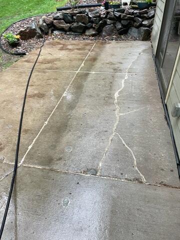 Cracked and Settled Concrete at Back Patio With Sealed Cracks