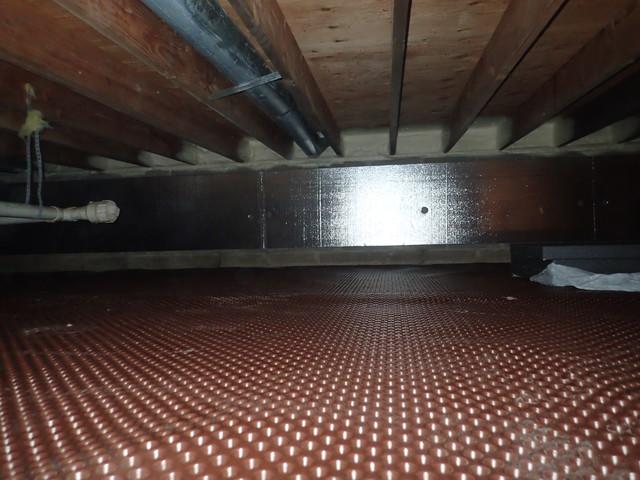 Drainage Matting is installed along the dirt floor. The drainage matting is dimpled to create air space for water to flow. 