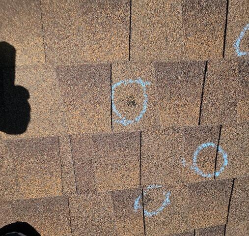Hail damage marked off by salesman.