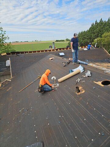 Crew members working on the roof.