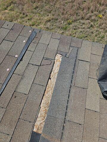 Missing shingles and damaged decking.