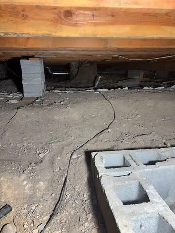Before: Dirt-Floor Crawl Space with Outdated Materials