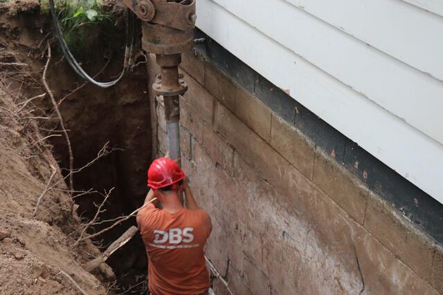 Helical Pier Installation Under Foundation