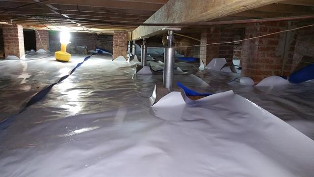 This picture was taken during the encapsulation installation.  The encapsulation material is cut and laid according to the personalized size of the crawl space so that it is fully covered; this dispels all animals, mold, dirt, and water out of the crawl space year round.