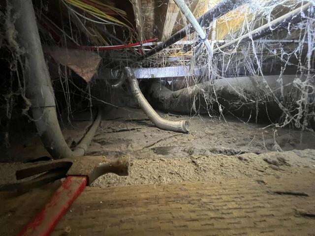 A nasty crawl space, in need of repair.
