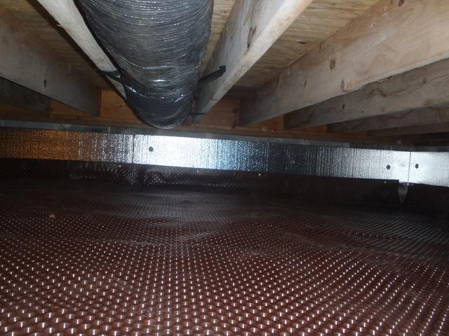 Dr. Energy Saver Delmarva has begun installing drainage matting along the dirt floor of the crawl space. The drainage matting is dimpled to create air space for water to flow. 